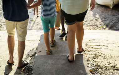 Rear view of caucasian family walking to the beach together