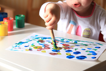 Kid draws with paint close-up