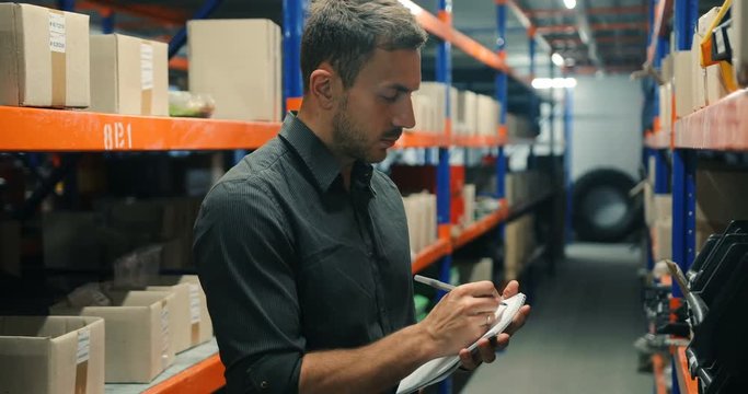 Warehouse manager businessman delivery courier exploring cargo information, working, perspective
