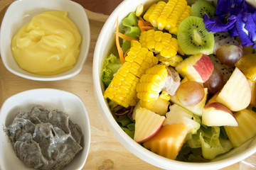Mix salad fruit and vegetable with black sesame dressing and egg dressing.
