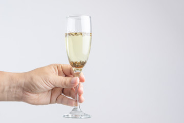 Hand holding glass of champagne with pest or insect