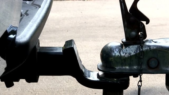 Boat trailer unsecured, unlatched then raised off of ball and hitch of truck