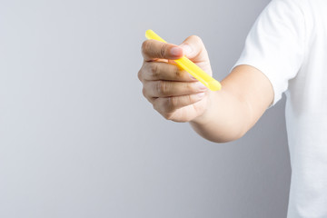 Hand holding a big or extra large drinking straw