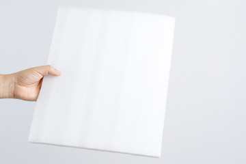 Hand holding foam fiber board