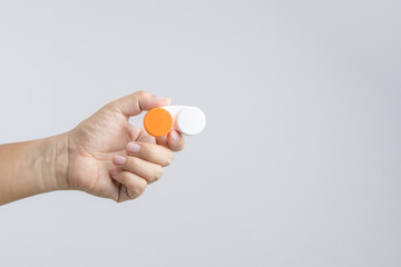 Hand holding contact lens case