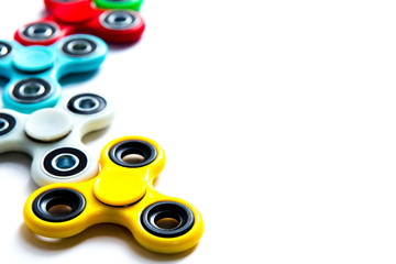 Fidget finger spinner, anxiety relief toy on white isolated background, copyspace. Concept relieving stress