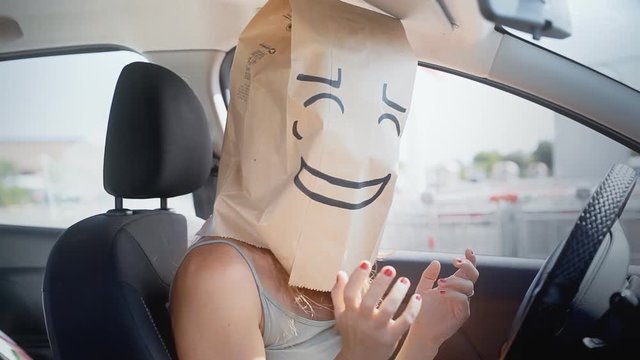 An embarrassed breadbag face in a car.
