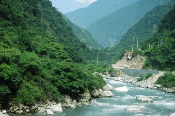 Zelfklevend Fotobehang river flowing from green mountain valley © nd700