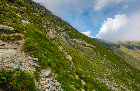 Steep slope on rocky hillside in clouds