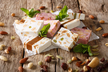 French fresh nougat with nuts and pumpkin seeds close-up. horizontal - obrazy, fototapety, plakaty