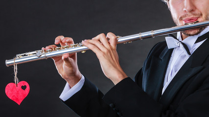 Male flutist with flute and heart. Love melody © anetlanda
