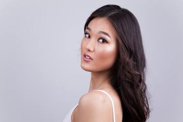 Fototapeta premium Portrait of a beautiful asian woman with makeup and light curls.