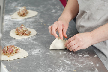 billet bun of dough with filling inside. Prepared for baking in baking production.