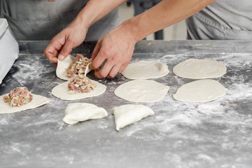 billet bun of dough with filling inside. Prepared for baking in baking production. Selective focus