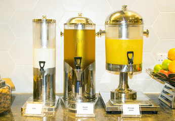 Fresh milk, Apple juice, Orange juice in water cooler for guess of seminar in the hotel.