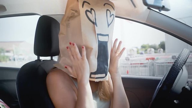 A breadbag face in a car, with a loving incredulous expression.
