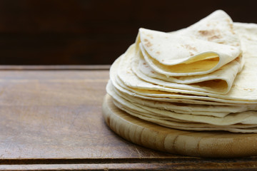 Flat bread tortillas pile on the table