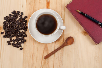 White Cup of coffee on Pine wood desktop table on top