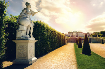 Upper Belvedere Castle (Schloos Belvedere) in Vienna, Austria. Detail of a sculpture pointing at the castle in the public park around the palace - obrazy, fototapety, plakaty
