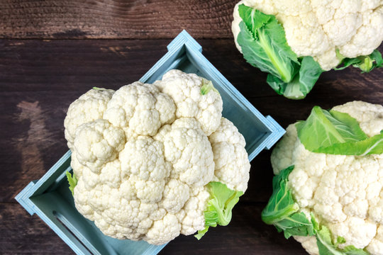 Cauliflowers on rustic textures with copy space