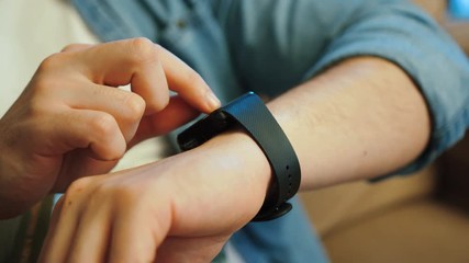 Young man hands using smart watch at home. Close up shot. - Powered by Adobe