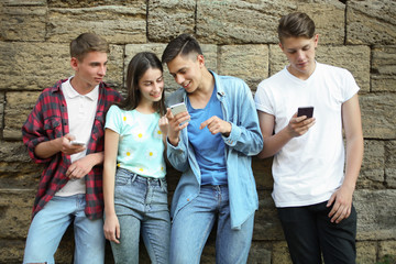 young friends with smartphones