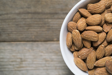 Almond nuts on wood background