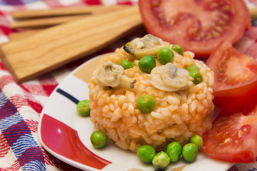 Seafood risotto with tomato and peas