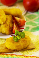 Wooden spoons with croquette and tomatoes