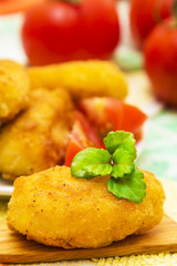 Wooden spoons with croquette and tomatoes