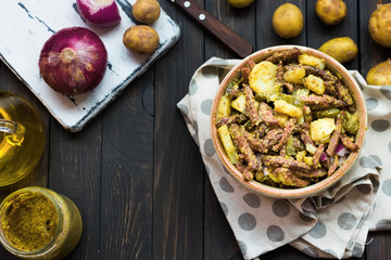 Bavarian salad with smoked meat on a dark background