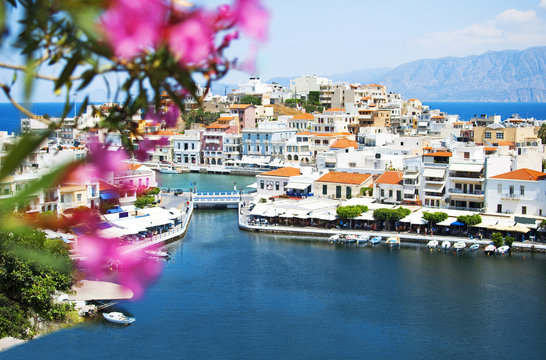 View of Lake Voulismeni in Agios Nikolaos, Crete, Greece. A beautiful coastal city with colorful buildings.