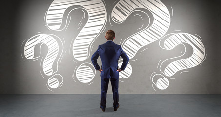 Businessman watching a question mark sketch on a wall 3D rendering