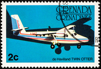 Small passenger aircraft De Havilland Twin Otter on postage stamp