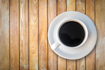 Black coffee in a cup on a wooden table.
