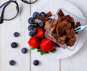 Chocolate with strawberry on wood background.