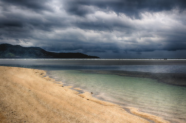 Dark sky over the ocean, the Small island of GILI Indonesia. Of the Indian ocean. - Powered by Adobe