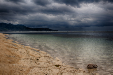 Dark sky over the ocean, the Small island of GILI Indonesia. Of the Indian ocean. - Powered by Adobe
