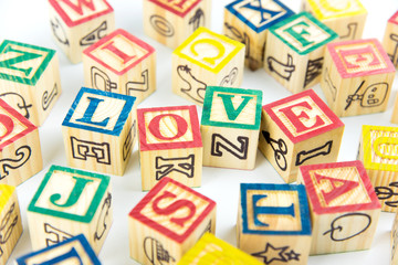 Fototapeta na wymiar wooden toy cubes are used to create the word love,Love concept or valentine day.