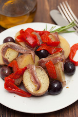 salad with anchovies on white plate