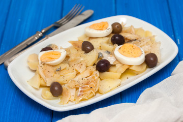 cod fish with boiled vegetables and egg on the dish