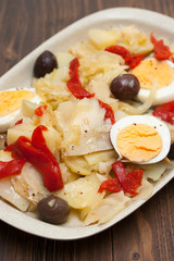 cod fish with boiled vegetables and egg on the dish