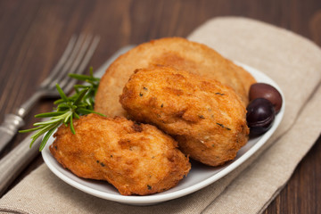 snack on white dish on brown wooden background