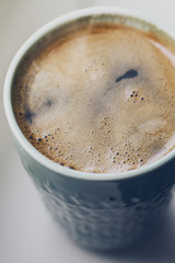 Closeup of tasty hot drink coffee espresso in ceramic mug with steam.