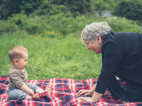 Grandmother and grandchild on picnic blanket