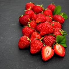 Strawberries on a black stone background