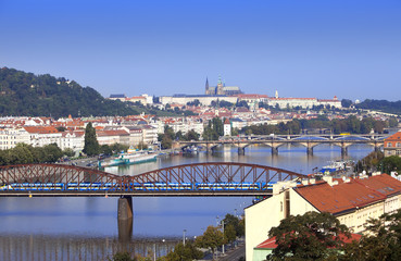Fototapeta na wymiar View of ancient roofs and bridges through Vltava. Prague. Czech Republic