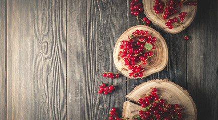 red currant berry on black wood boards