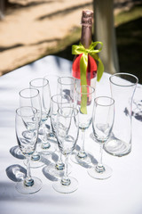 Champagne and glass at a wedding ceremony on the beach.