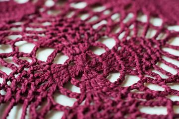 Beautiful red texture of knitted shawls. Texture of knitted white petals. Knitting stitch, shawls, plaid handmade. Maro knitting.